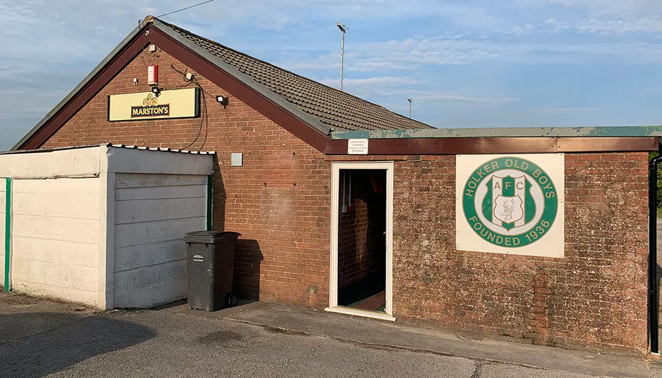 Holker crest beside the turnstiles